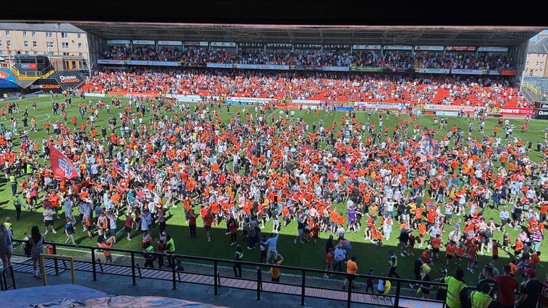 Fans invade the pitch after Dundee United's victory over Aberdeen FC in May. Pic: PA 