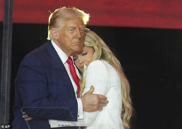 President Donald Trump embraces Erika Kirk at a memorial for Charlie Kirk in September