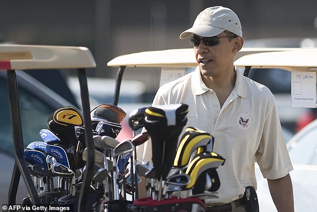 President Barack Obama walks to his golf cart as he arrives at the President's course