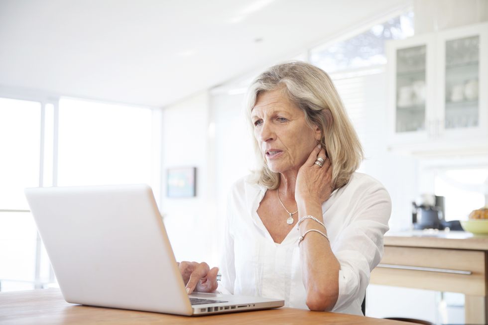 Pension saver looks worried at laptop