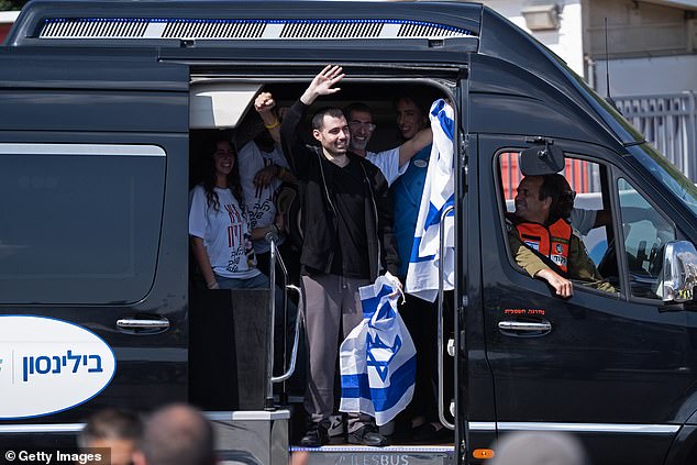Former hostage Guy Gilboa-Dalal waves to supporters outside Beilinson Hospital in the Rabin Medical Centre on October 13, 2025 in Petah Tikva, Israel