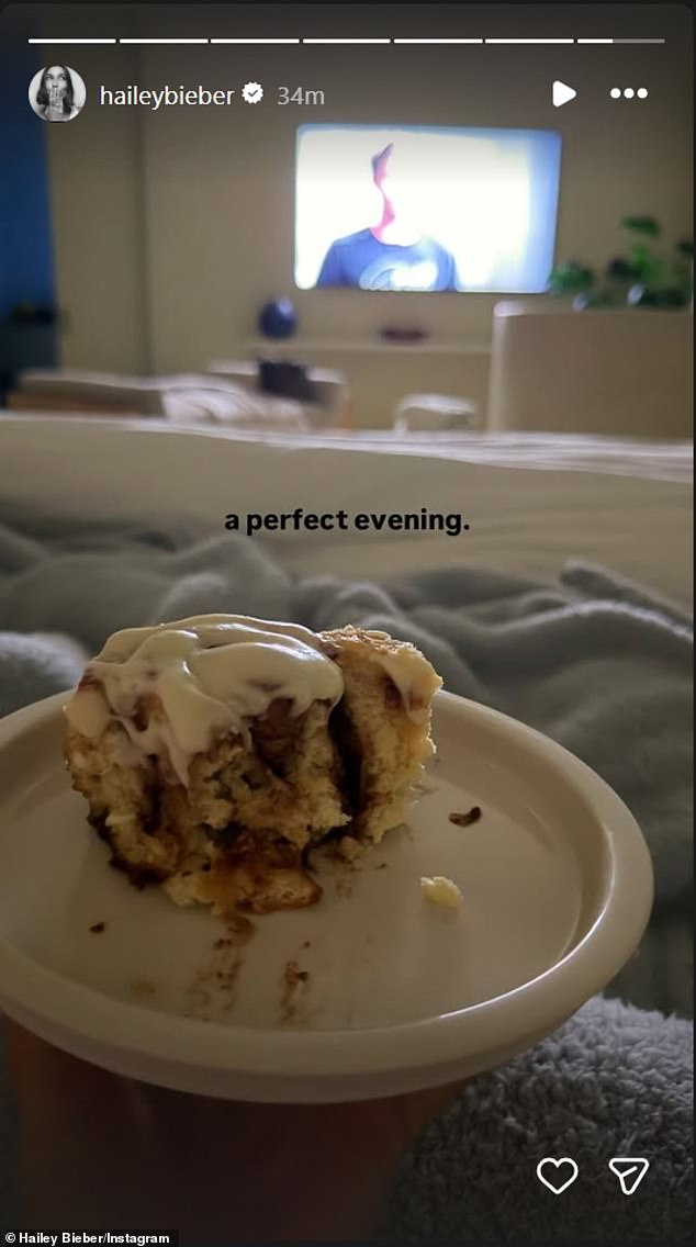 Baldwin called it 'a perfect evening' as she relaxed in bed, half-eaten cinnamon roll atop her, while watching a mystery program on TV