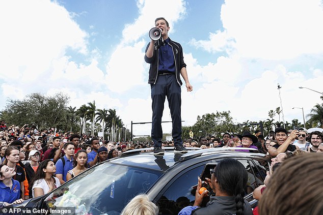 Cameron Kasky addresses students at a rally at Marjory Stoneman Douglas High School after participating in a county wide school walk out in Parkland, Florida on February 21, 2018