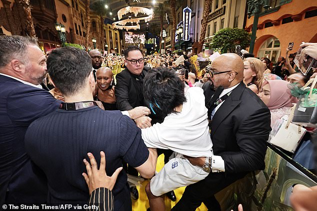 According to the Singaporean paper The Straits Times, the judge said that Wen, pictured being restrained by security, had planned the disturbing move to get hits on social media