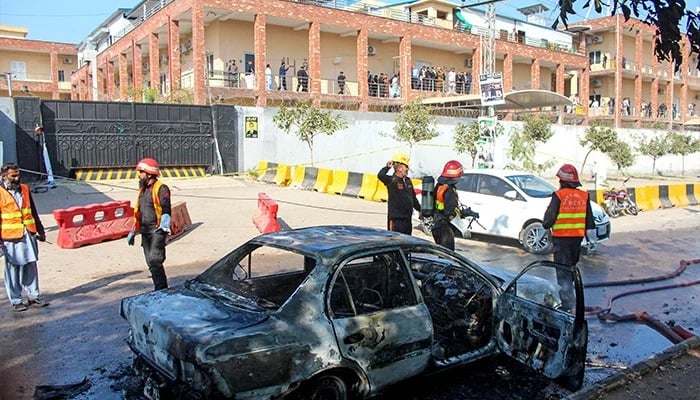Firefighter douses a vehicle after a blast outside a court building in Islamabad on November 11, 2025. — Reuters