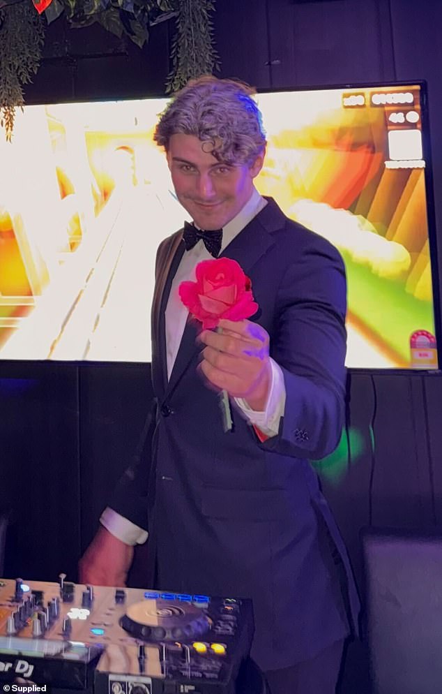 Pictured: The photo features what appears to be Bear's son, Charlie Myrden, 20, holding a rose and dressed in the Golden Bachelor's familiar black tux