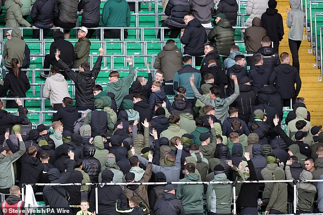 Celtic fans turn their back and make gestures during the minute's silence to mark the war dead