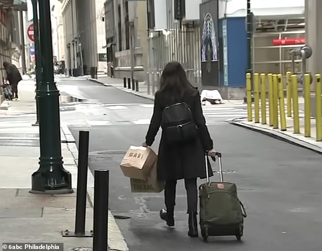 A guest is seen abruptly leaving the Sonder hotel she was staying at in Philadelphia with her luggage in tow