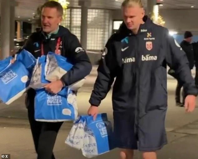 Erling Haaland incredibly celebrated guiding Norway to the brink of next summer's World Cup by collecting an estimated 70 cheeseburgers for his team-mates