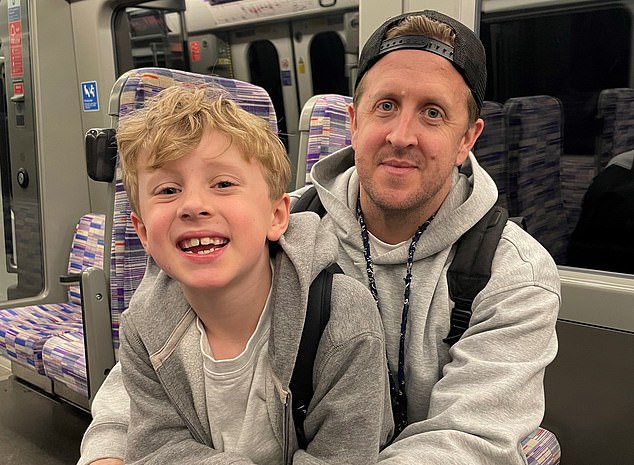 British Airways loyalist: Adam Smith with his son Jude, seven missed out on a night in Dubai after the airline cancelled their flights