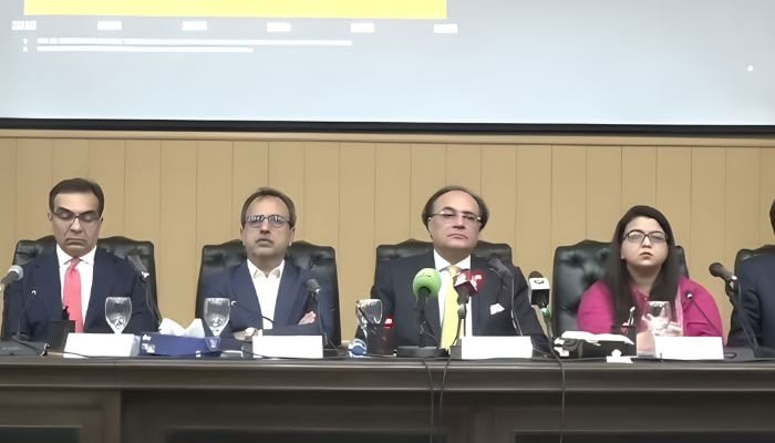 Finance Minister Muhammad Aurangzeb (second right) addresses a presser in Islamabad on November 3, 2025. — Screengrab Geo News