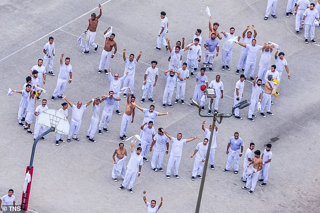 Pictured: Detainees react as they stand at the recreational areas at the Krome Detention Center in West Miami, Florida on Friday, July 4, 2025