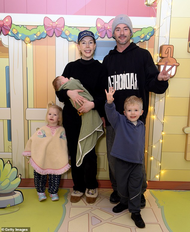 Katherine Ryan cradled her newborn baby girl, Holland, as she and her family attended a Bluey's Aussie Christmas event at Bluewater Shopping Centre in Greenhithe on Saturday