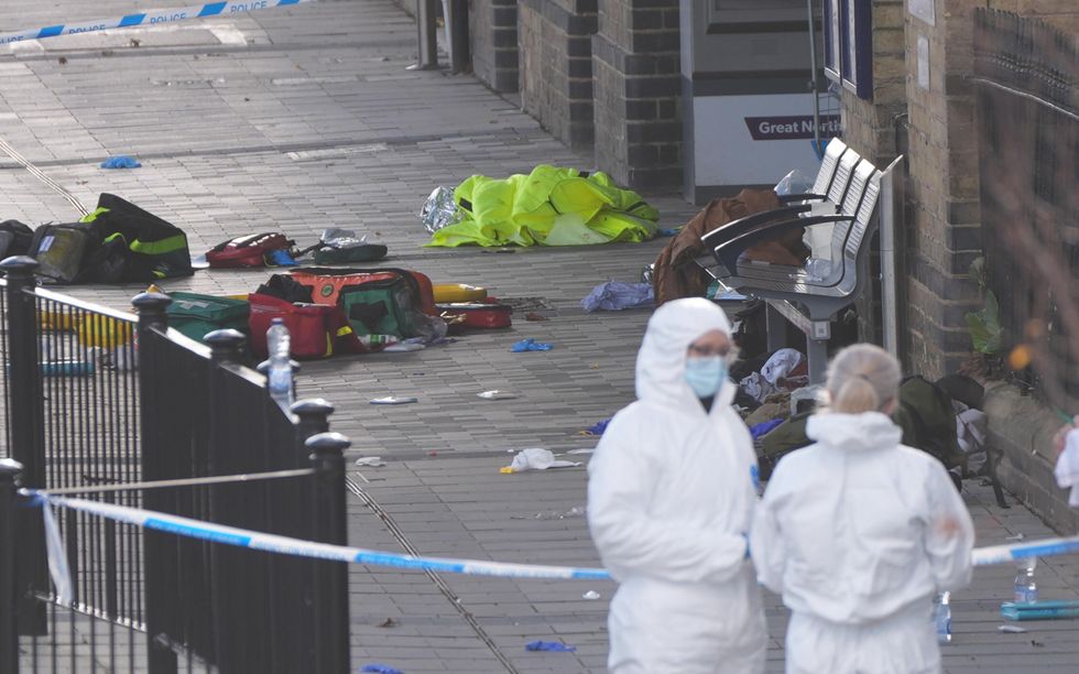 Forensic teams on the platform in Huntingdon on Sunday after the stabbing
