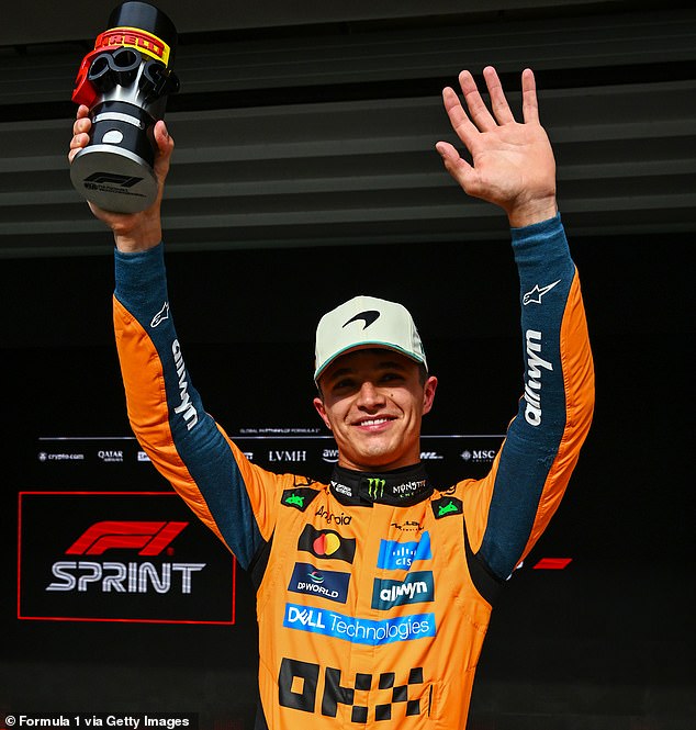Lando Norris holds aloft his Pirelli Sprint Award after finishing on pole in Brazil on Friday