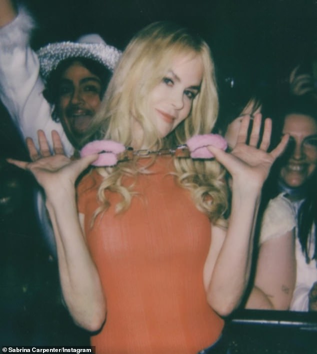 Nicole Kidman posed with her pink fluffy handcuffs after being 'arrested' by Sabrina Carpenter while attending the singer's concert in Nashville on November 4