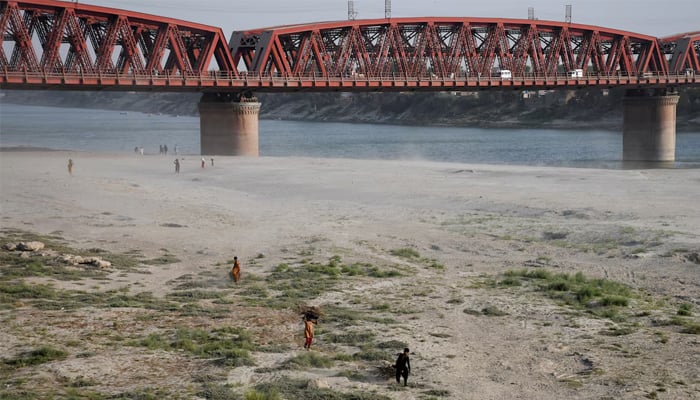 People walk on the dry riverbed of the Indus River in Hyderabad April 24, 2025. — Reuters