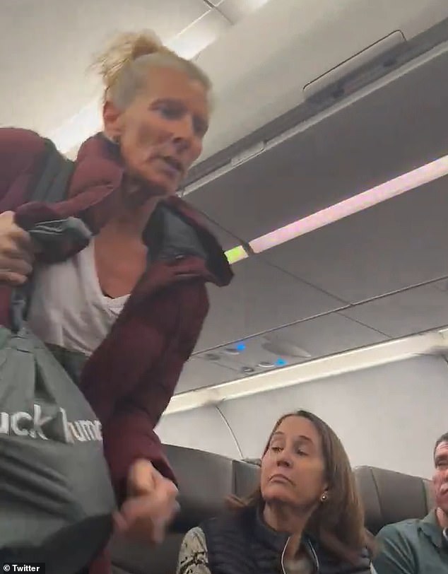 An irate passenger forced a flight carrying four congressmen to Washington DC to be grounded as footage showed her declaring: 'We live in a fascist state'