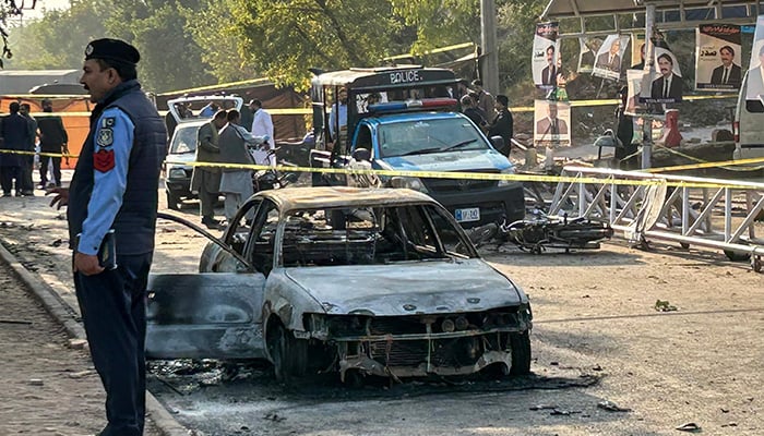Policemen examine damaged vehicles after a suicide blast outside the district court in Islamabad on November 11, 2025. — AFP