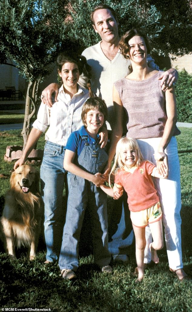 Within just six years of Poltergeist's 1982 release, four cast members were dead - including two of its child stars - sparking decades of rumors that the hit movie was haunted (Pictured: Dominique Dunne (left), Craig T Nelson (center back), Oliver Robins (center front), JoBeth Williams (right) and Heather O'Rourke (right front) in 1982)