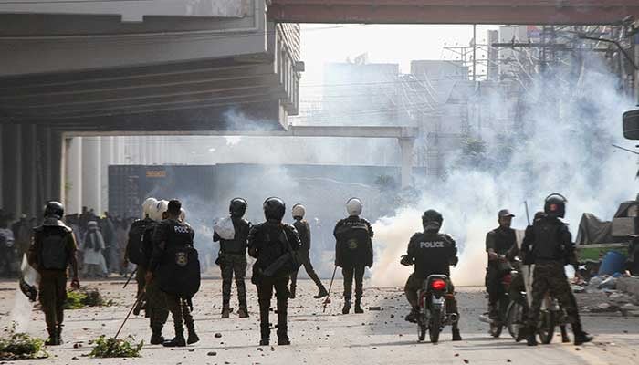 Police officers stand as they use tear gas to disperse supporters of Tehreek-e-Labbaik Pakistan (TLP) during a solidarity march for Gaza in Lahore, Pakistan, October 10, 2025. — Reuters