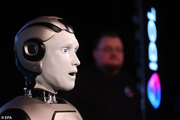 The bot, known as AIDOL, staggered out on stage triumphantly to the Rocky theme song in front of around 50 journalists before the machine shuffled to the left and waved to the audience