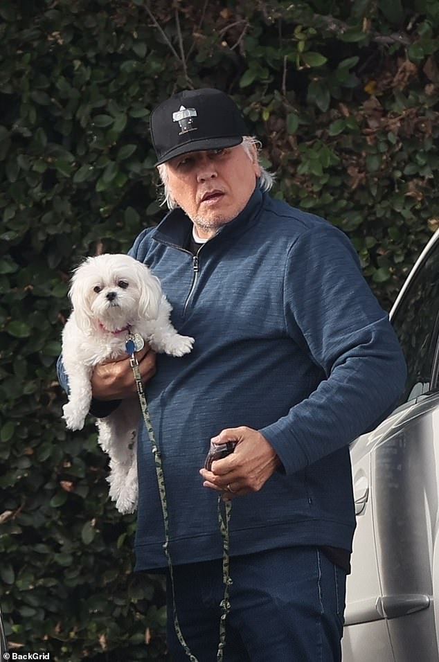 Beltran wore a blue zip-down jacket, jeans, and a black hat