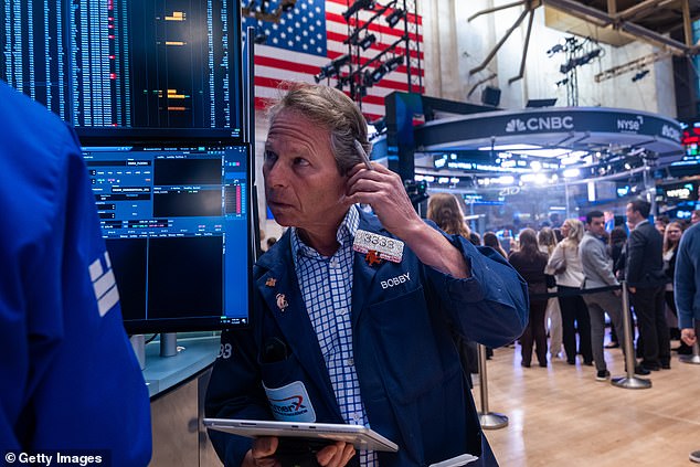 Traders work on the floor of the New York Stock Exchange on November 7