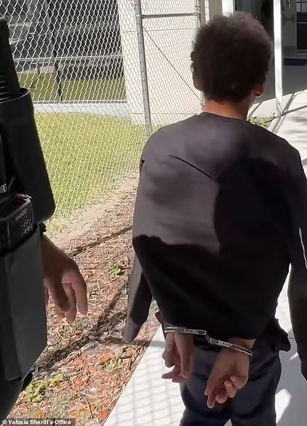 Curry, with his arms handcuffed behind his back, was marched into a cell on Monday after he allegedly threatened Highbanks Learning Center in Deltona