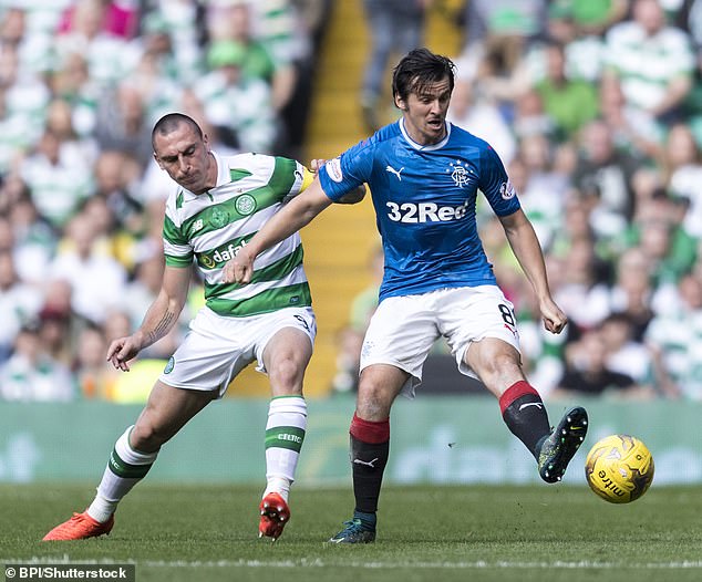Joey Barton battles with Celtic captain Scott Brown on his Old Firm derby debut