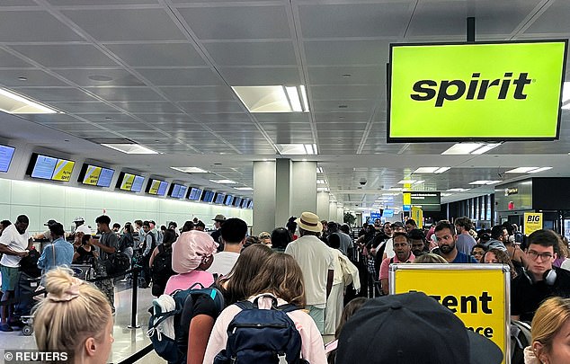 Stock image: Travelers stand in line at the check-in counter at Spirit Airlines at Newark Liberty International Airport on June 30