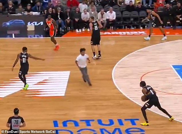 A man in a white t-shirt ran onto the court as the Clippers and Nuggets were playing