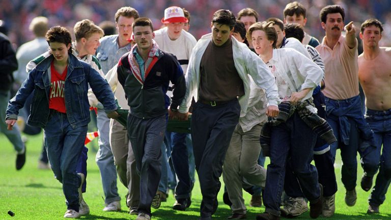 A fan is taken from the pitch after being injured at Hillsborough. Pic: Action Images via Reuters