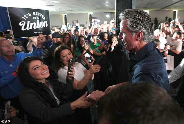 Donna Bojarsky, a civic activist and political strategist, said that Newsom has 'captured the zeitgeist and spirit of the voters.' He is pictured here greeting supporters after speaking during a rally with the Harris County Democrats last month