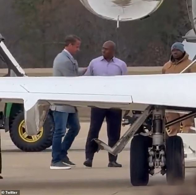 Kiffin (left) was seen leaving a chauffeured SUV and walking across the tarmac to his waiting plane as hundreds of his former supporters offered a chorus of boos and expletives