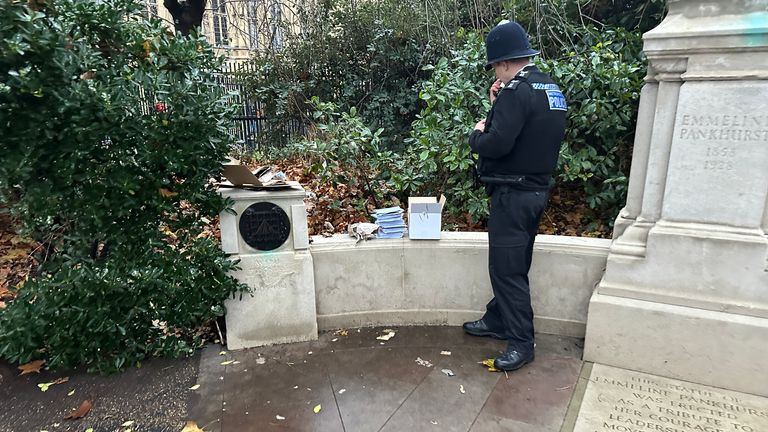 A police officer inspecting the box of cards that triggered a lockdown of Westminster.
