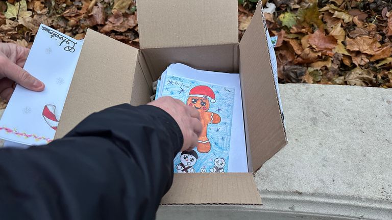 The box of Christmas cards being inspected for signs of danger.