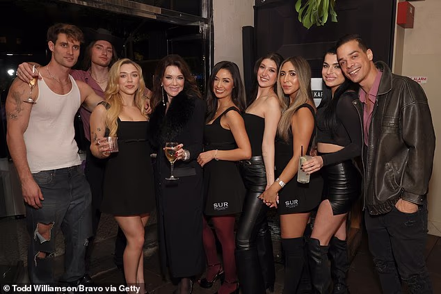 The cast of the revamped series are pictured posing inside SUR with Lisa