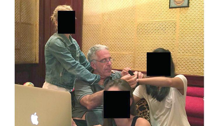 Epstein with three women whose faces have been redacted. Pic: @OversightDems