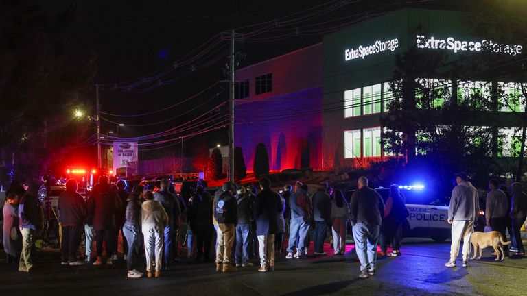 People gather outside a facility where the suspect was found. Pic: AP
