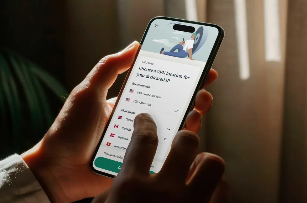 a person holds the expressvpn app on iPhone  