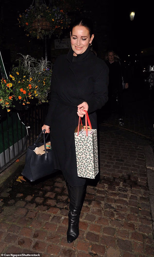 Kirsty Gallacher opted for an all-black ensemble for the event as she wore a wrap coat and knee-high leather boots