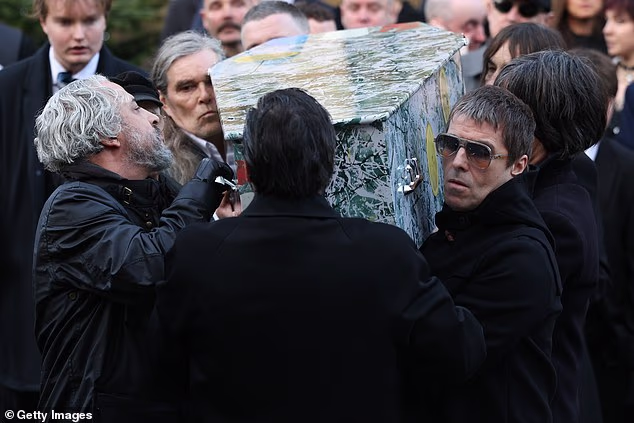 Also seen with the coffin were the Stone Roses' Ian Brown and Primal Scream's Bobby Gillespie