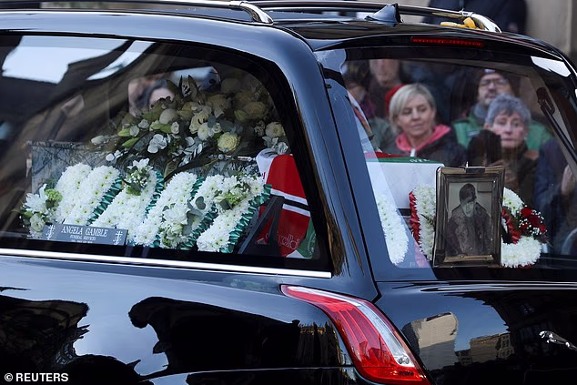 A framed photograph of Gary Mounfield was seen arriving among floral tributes