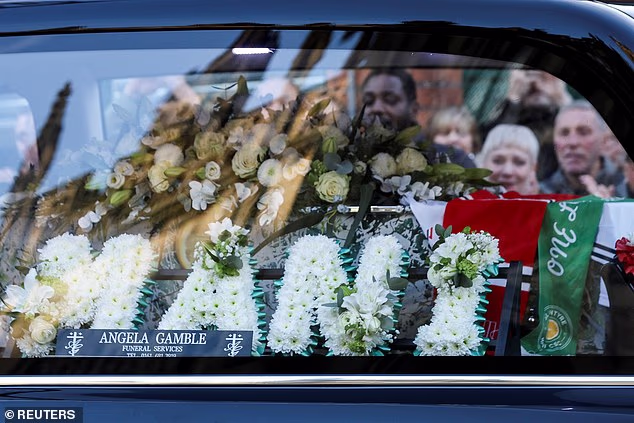 Mourners watching on outside Manchester Cathedral saw a hearse carrying this floral tribute