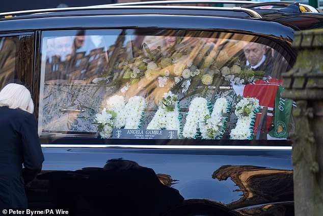 Flowers reading 'Mani' are seen in the hearse on arrival for the Manchester Cathedral service