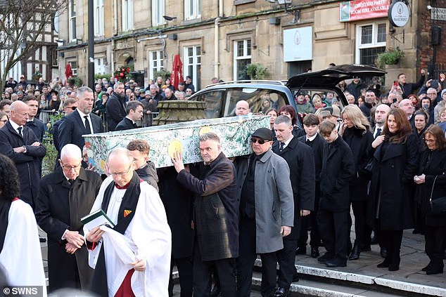 The coffin was applauded as it arrived at Manchester Cathedral for the 11.30pm service