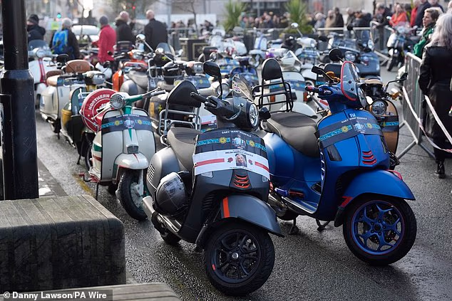 A parade of scooters accompanying the procession carried their separate tributes to Mani