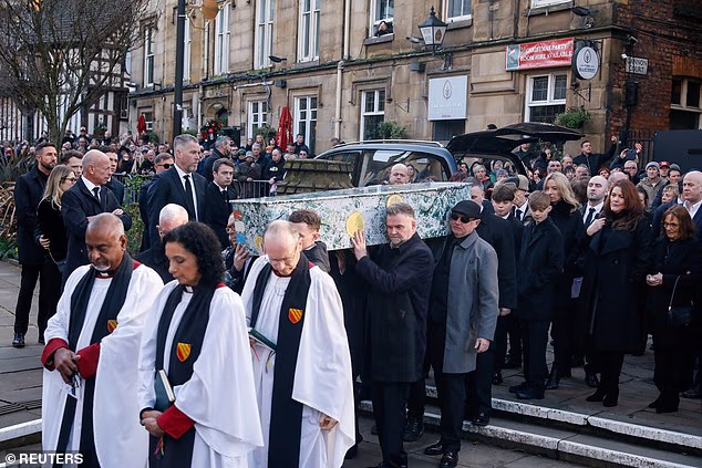 Pallbearers carry the coffin of Gary "Mani" Mounfield, former member of rock bands The Stone Roses and Primal Scream