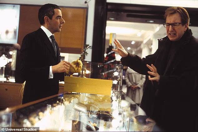 Originally, Rowan Atkinson's character was supposed to be a Christmas Angel. His elaborate gift-wrapping was indeed deliberate, as the original storyline was that he was to be an angel on a secret mission to stop Alan Rickman's character from having the affair